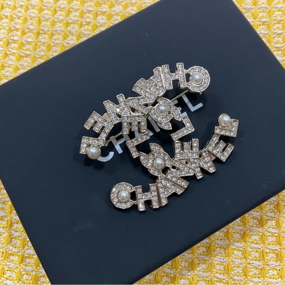 CHANEL Silver Logo Brooch with Pearls